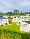 static caravans on the grass in the sun