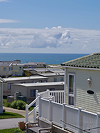caravan park on a hill with the sea in the distance