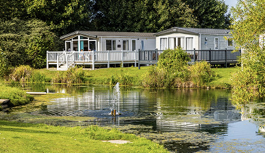 photo of two caravans on a lakeside view