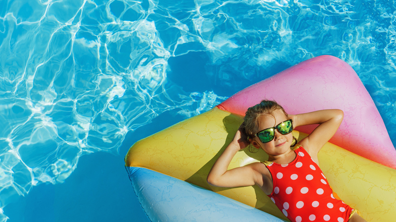 Child in swimming pool. Having fun on holiday at the holiday park pool.