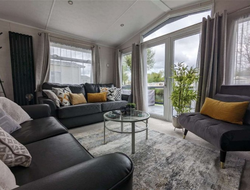 Interior of a static caravan holiday home, with large windows overlooking the outdoor scenery at this popular caravan holiday park an with indoor pool.